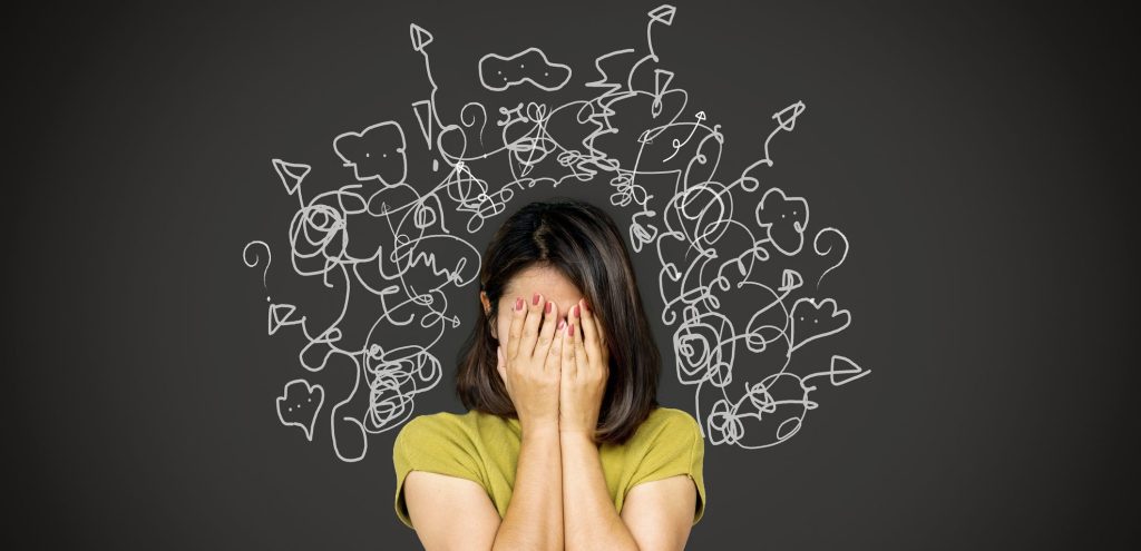 a person holding the weight of multiple emotional energy