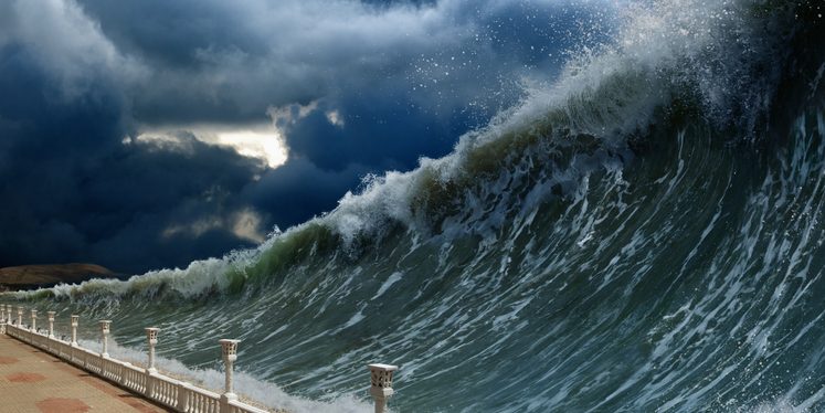 A massive wave surges toward a deserted promenade under storm-dark skies, moments before impact.